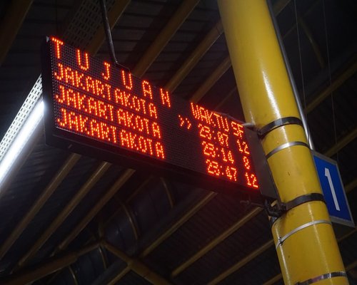 Orang menunggu di stasiun saat matahari terbenam